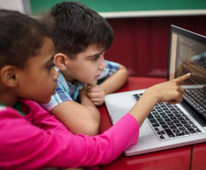 Elementary students on a computer together