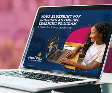 Flexpoint page on a laptop with some text and a girl smiling while using a computer