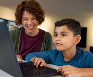 Woman helping boy learn